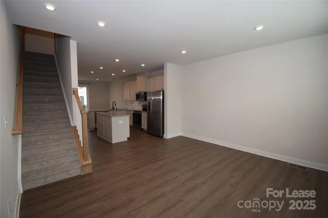a view of a kitchen with a sink and a refrigerator