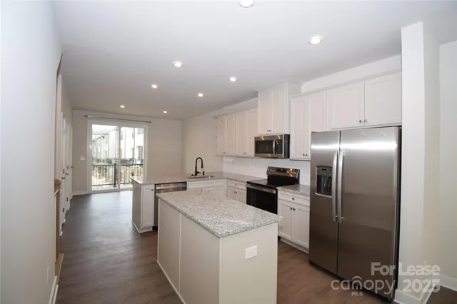 a kitchen with a stove a refrigerator and a sink