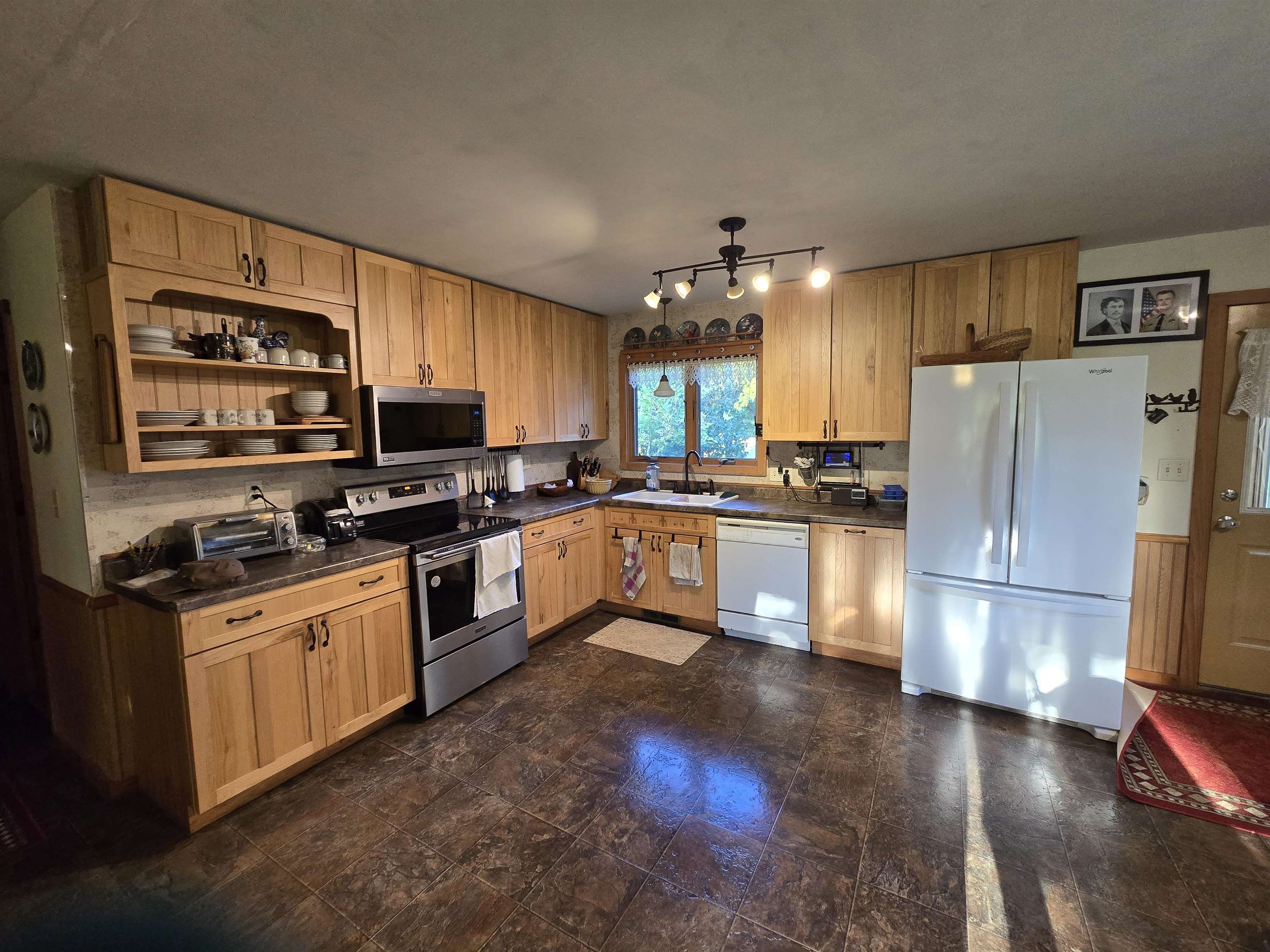 17065 Highway 64 Polo, IL 61064 - Photo 13 of 26 a kitchen with granite countertop a refrigerator stove top oven and sink