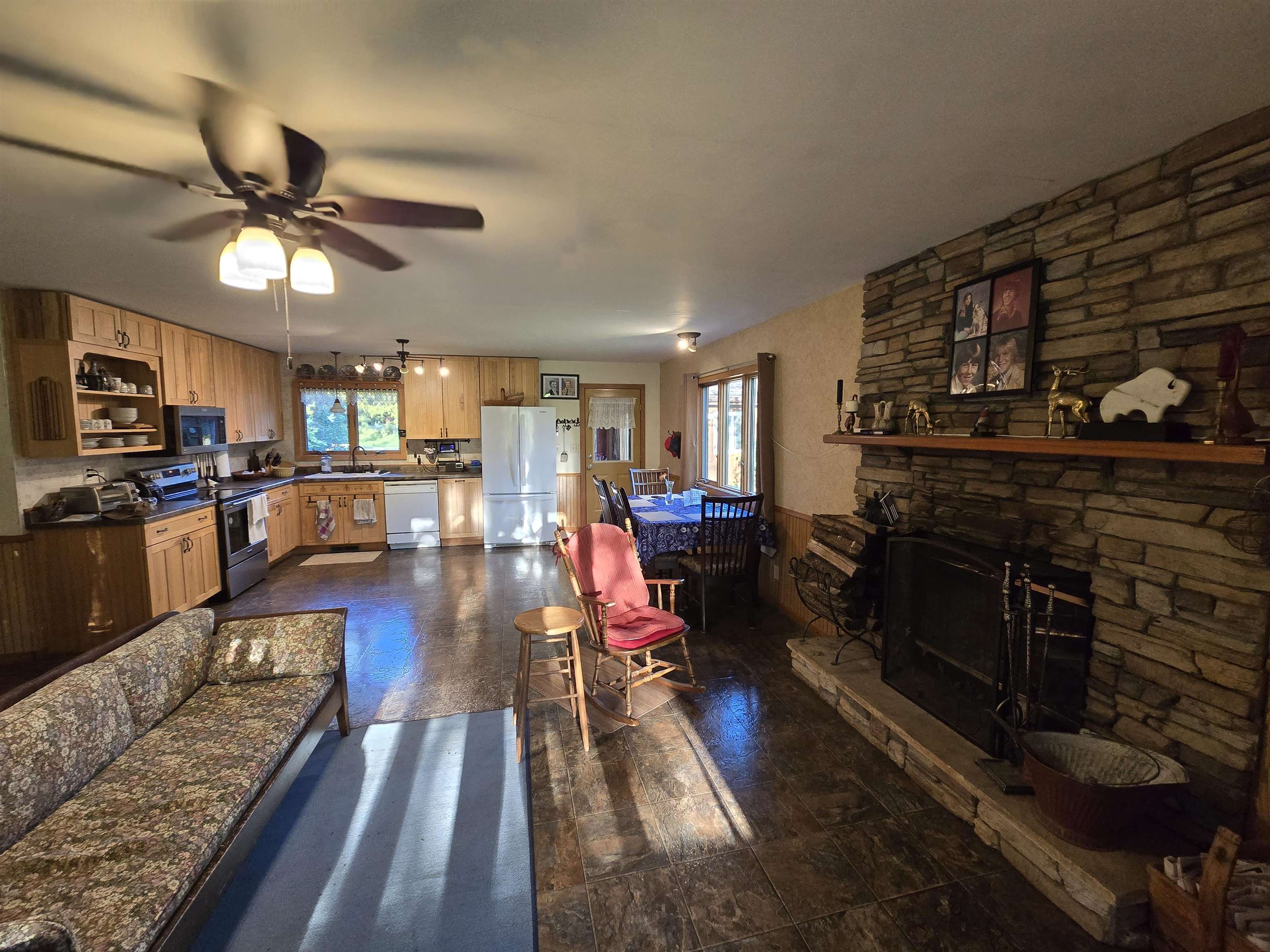 17065 Highway 64 Polo, IL 61064 - Photo 16 of 26 a living room with stainless steel appliances furniture a fireplace and wooden floor