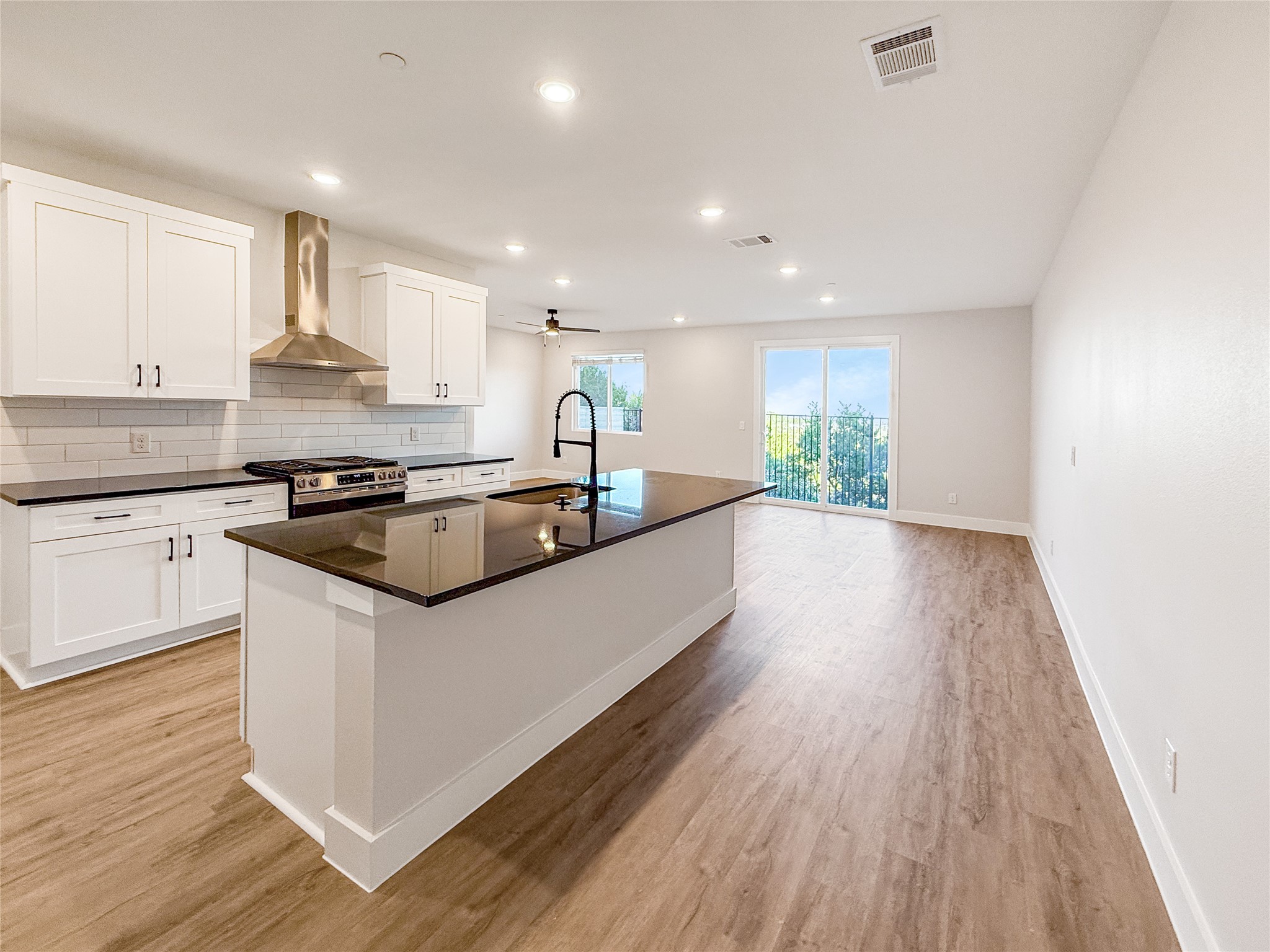 5609 Mobeetie Loop Bee Cave, TX 78738 - Photo 5 of 23 kitchen with granite countertops and island