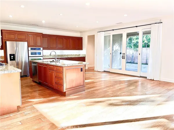 a kitchen with stainless steel appliances granite countertop a stove top oven and cabinets