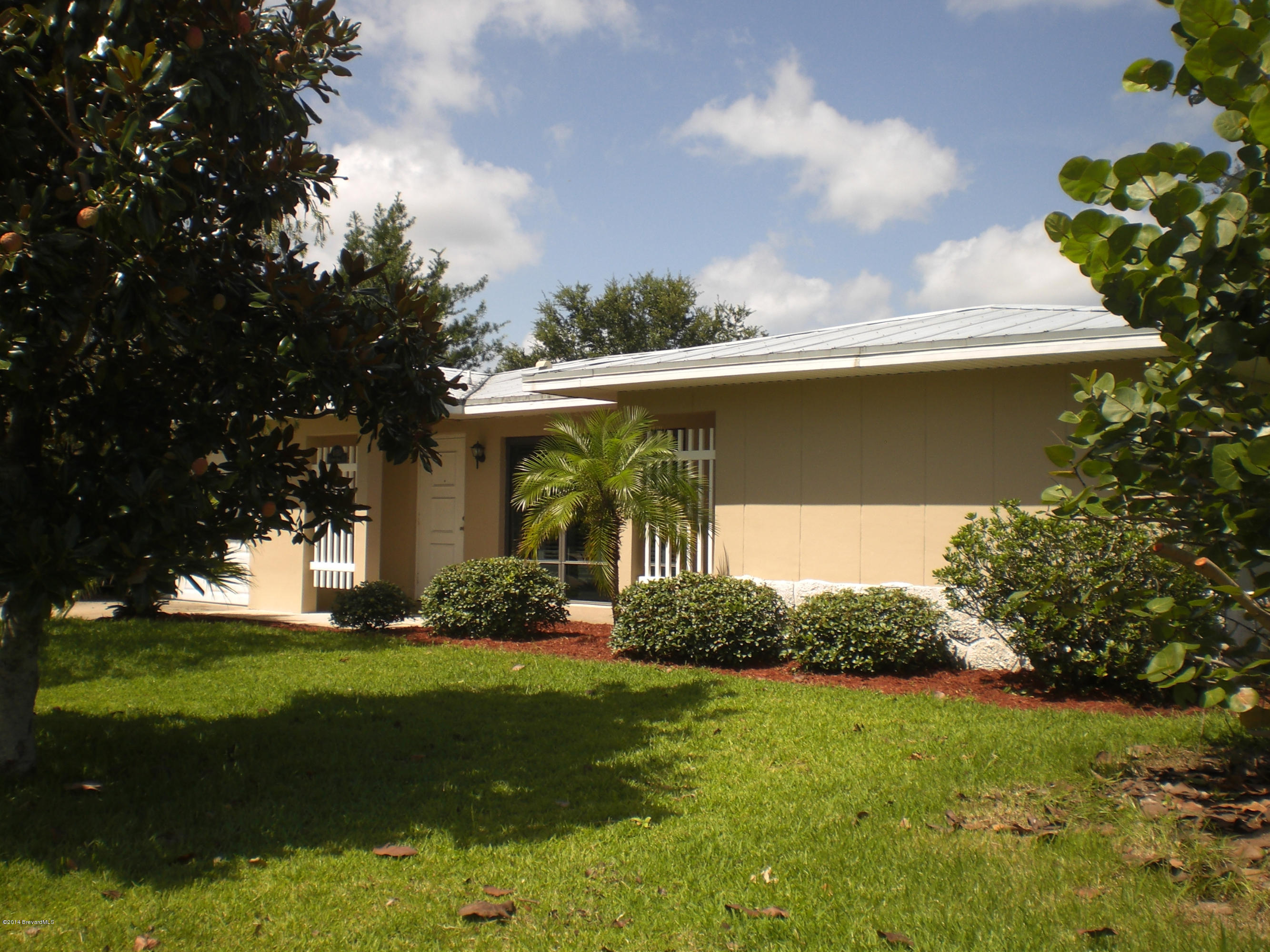 1180 Cotton Road Northeast Palm Bay, FL 32905 - Photo 1 of 18 a view of a house with a yard