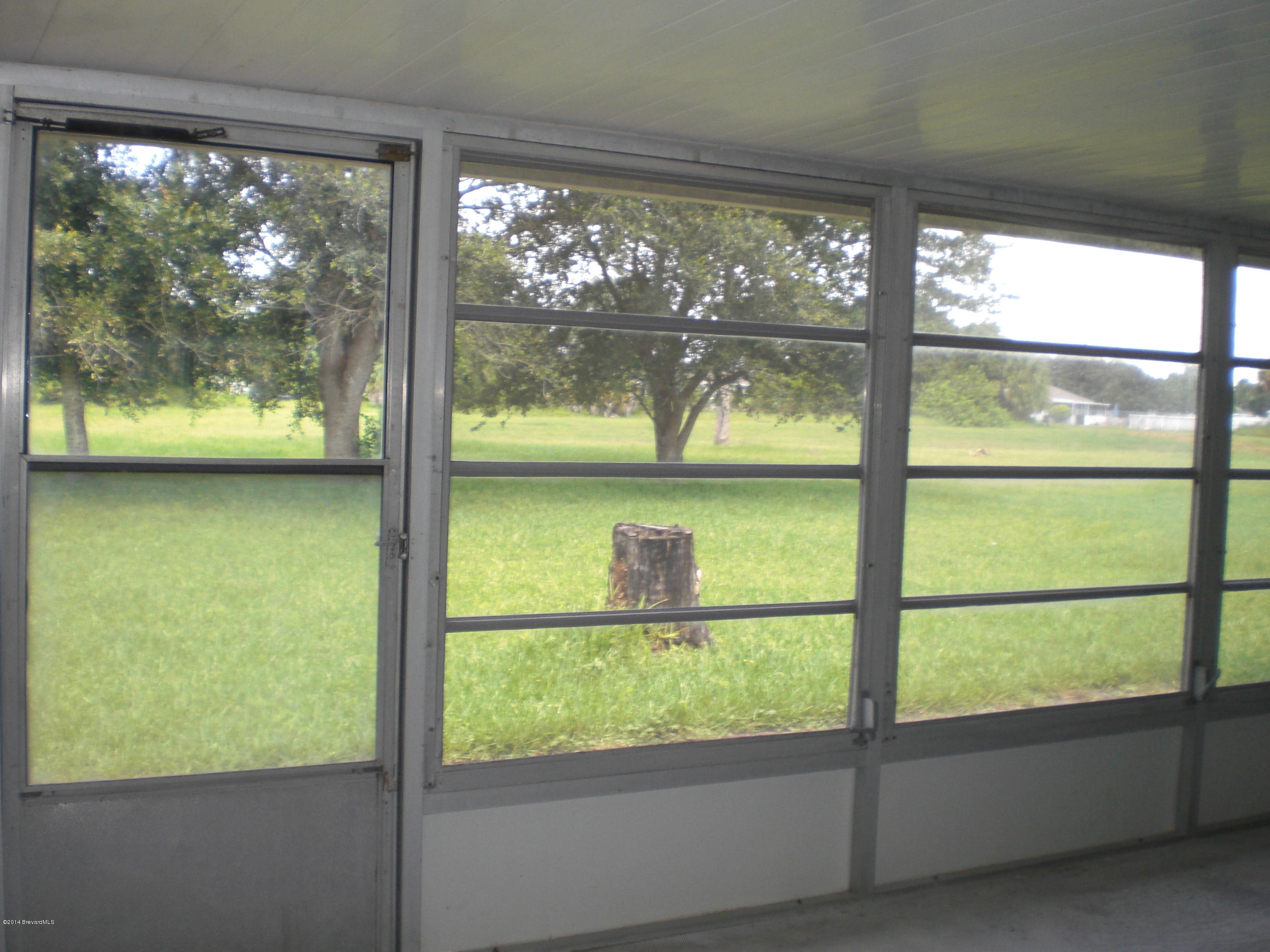 1180 Cotton Road Northeast Palm Bay, FL 32905 - Photo 15 of 18 a view of a glass door with a yard from a window