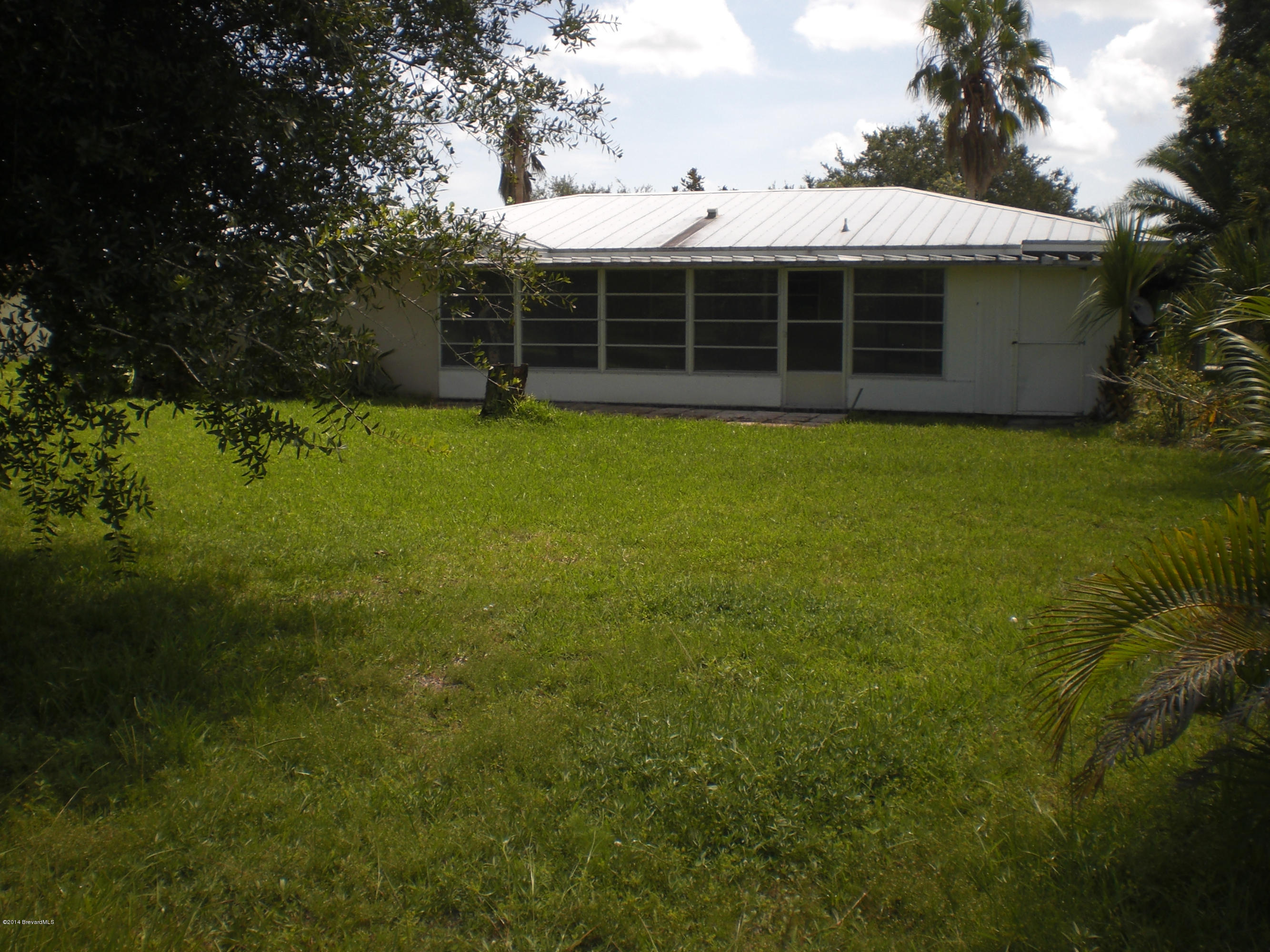1180 Cotton Road Northeast Palm Bay, FL 32905 - Photo 17 of 18 a view of a house with a backyard