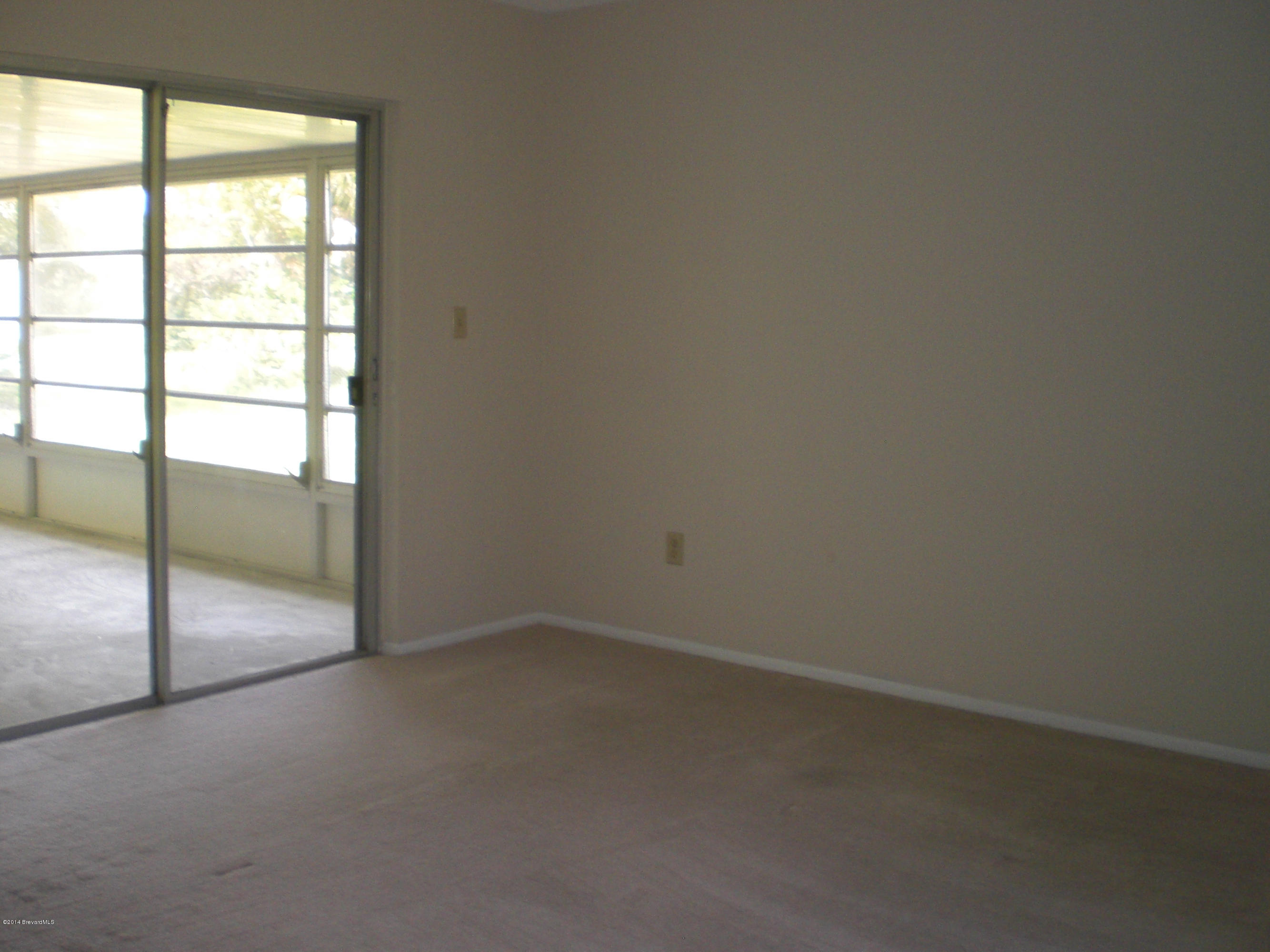 1180 Cotton Road Northeast Palm Bay, FL 32905 - Photo 9 of 18 an empty room with sliding door