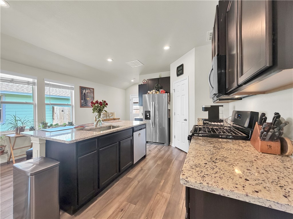 2301 Soothing Street Corpus Christi, TX 78418 - Photo 12 of 25 a kitchen with stainless steel appliances granite countertop a sink stove and refrigerator