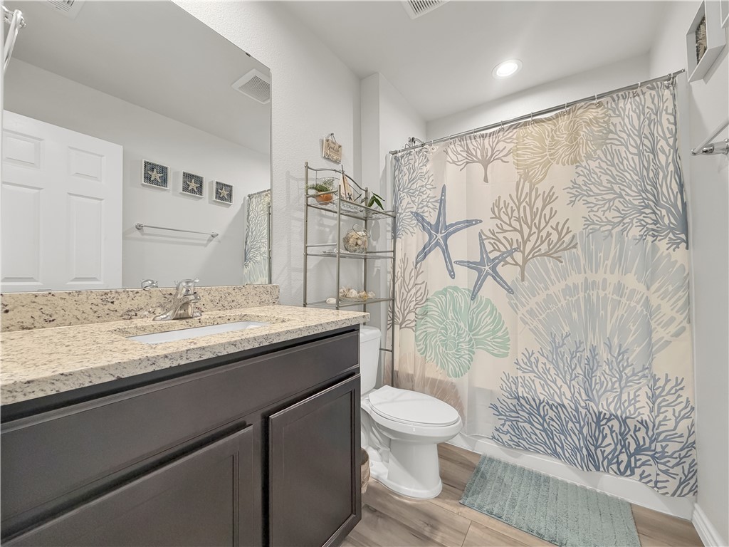 2301 Soothing Street Corpus Christi, TX 78418 - Photo 20 of 25 a bathroom with a granite countertop sink toilet and shower