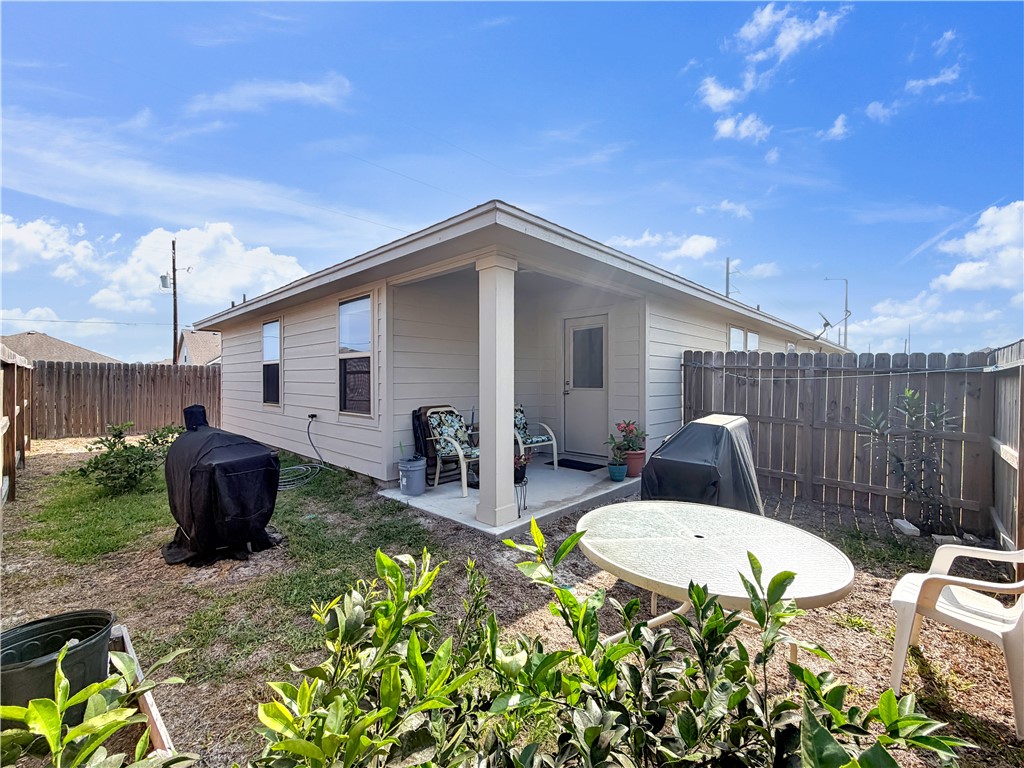 2301 Soothing Street Corpus Christi, TX 78418 - Photo 24 of 25 a view of a backyard with table and chairs potted plants with wooden fence