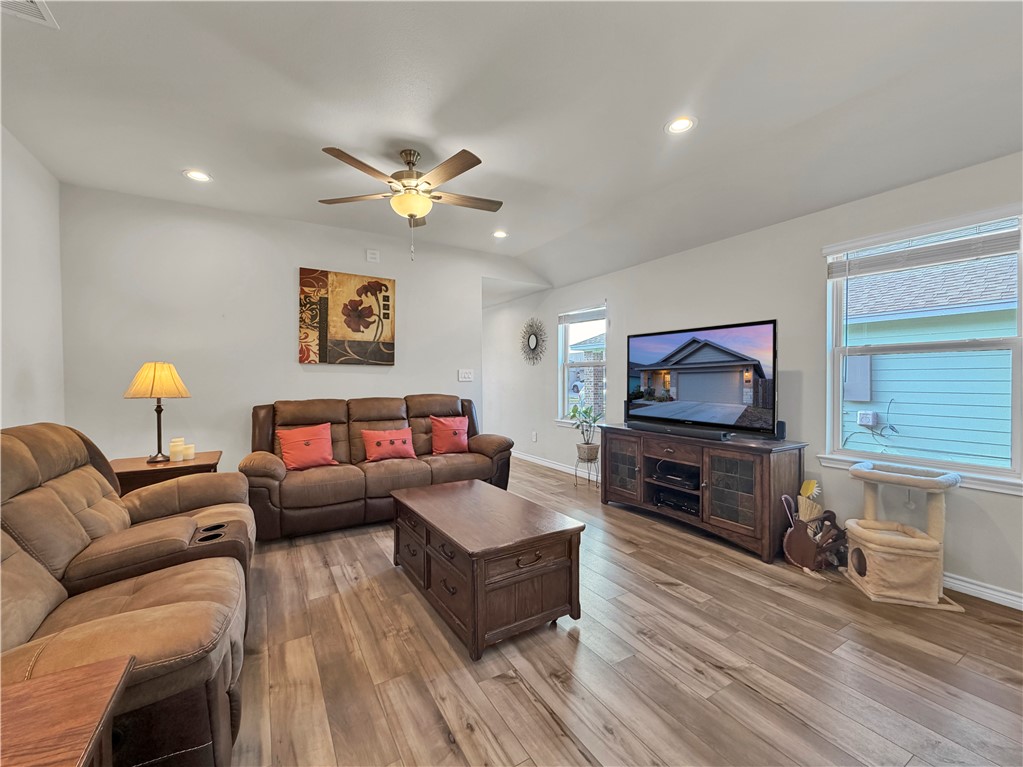 2301 Soothing Street Corpus Christi, TX 78418 - Photo 6 of 25 a living room with furniture a flat screen tv and a fireplace