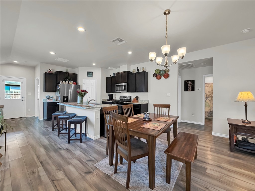 2301 Soothing Street Corpus Christi, TX 78418 - Photo 7 of 25 a view of a dining room with furniture and wooden floor