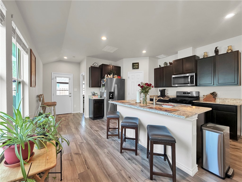 2301 Soothing Street Corpus Christi, TX 78418 - Photo 9 of 25 a kitchen with a table chairs microwave and cabinets