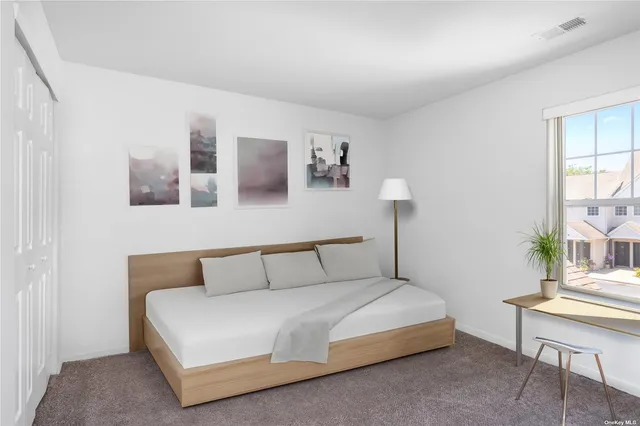 a bedroom with a bed and a table