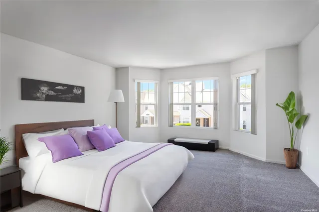 a spacious bedroom with a bed and a couch