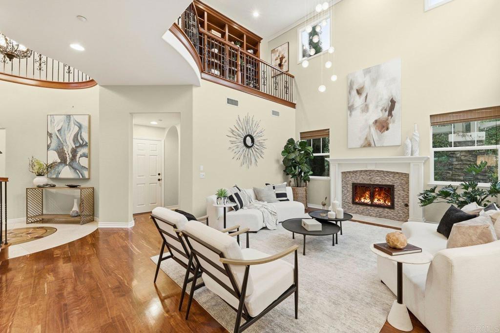 1375 Ravean Court Encinitas, CA 92024 - Photo 12 of 75 a living room with furniture a fireplace and a chandelier