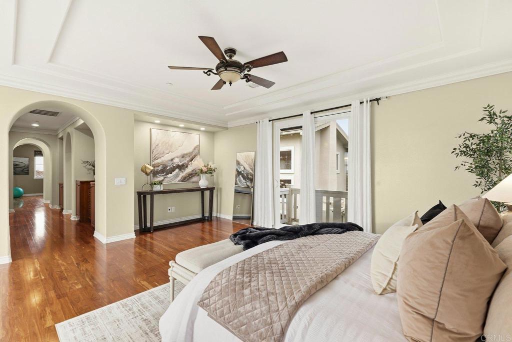 1375 Ravean Court Encinitas, CA 92024 - Photo 47 of 75 a bedroom with a large bed and a chandelier