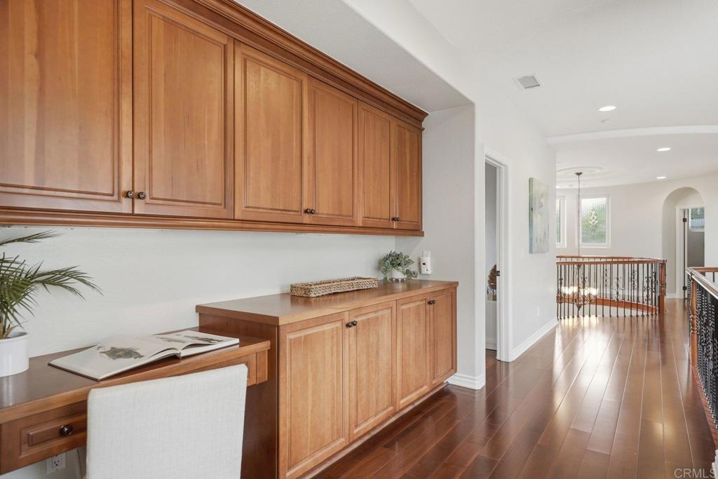 1375 Ravean Court Encinitas, CA 92024 - Photo 59 of 75 a view of a kitchen with fridge and wooden floor