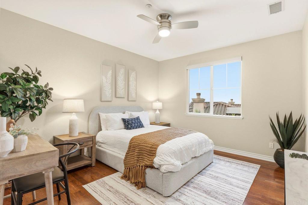 1375 Ravean Court Encinitas, CA 92024 - Photo 60 of 75 a bedroom with a large bed and a potted plant