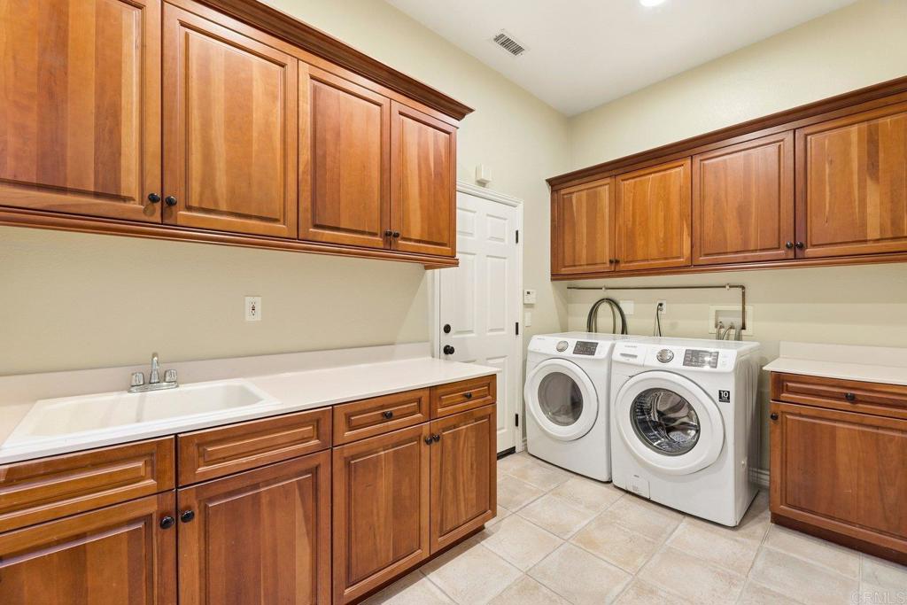 1375 Ravean Court Encinitas, CA 92024 - Photo 65 of 75 a utility room with dryer and washer