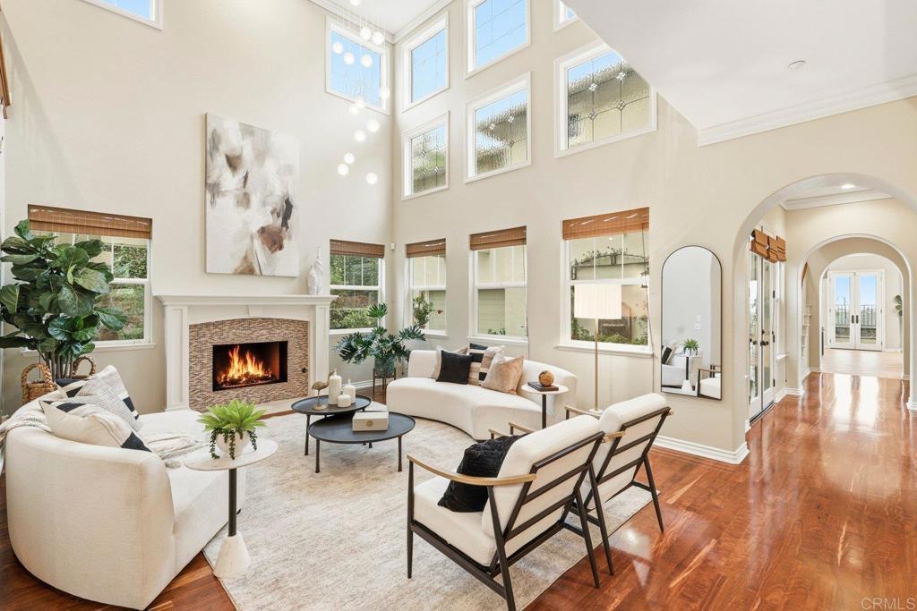 1375 Ravean Court Encinitas, CA 92024 - Photo 9 of 75 a living room with furniture a fireplace and potted plants