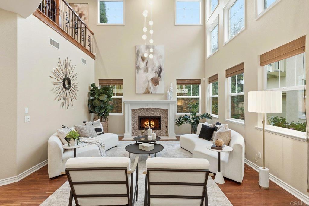 1375 Ravean Court Encinitas, CA 92024 - Photo 10 of 75 a living room with furniture a fireplace and a chandelier