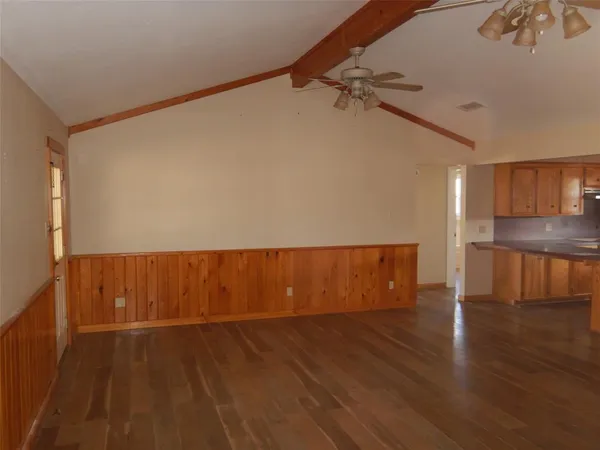a view of a room with wooden floor