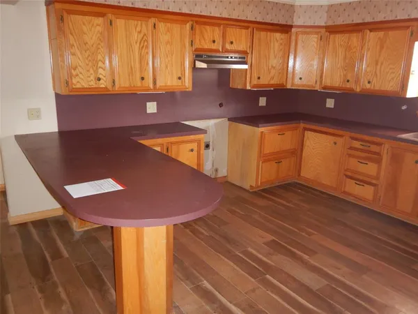 a kitchen with wooden cabinets and a sink