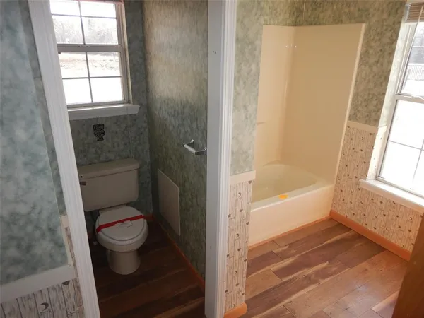 a bathroom with a toilet and a shower