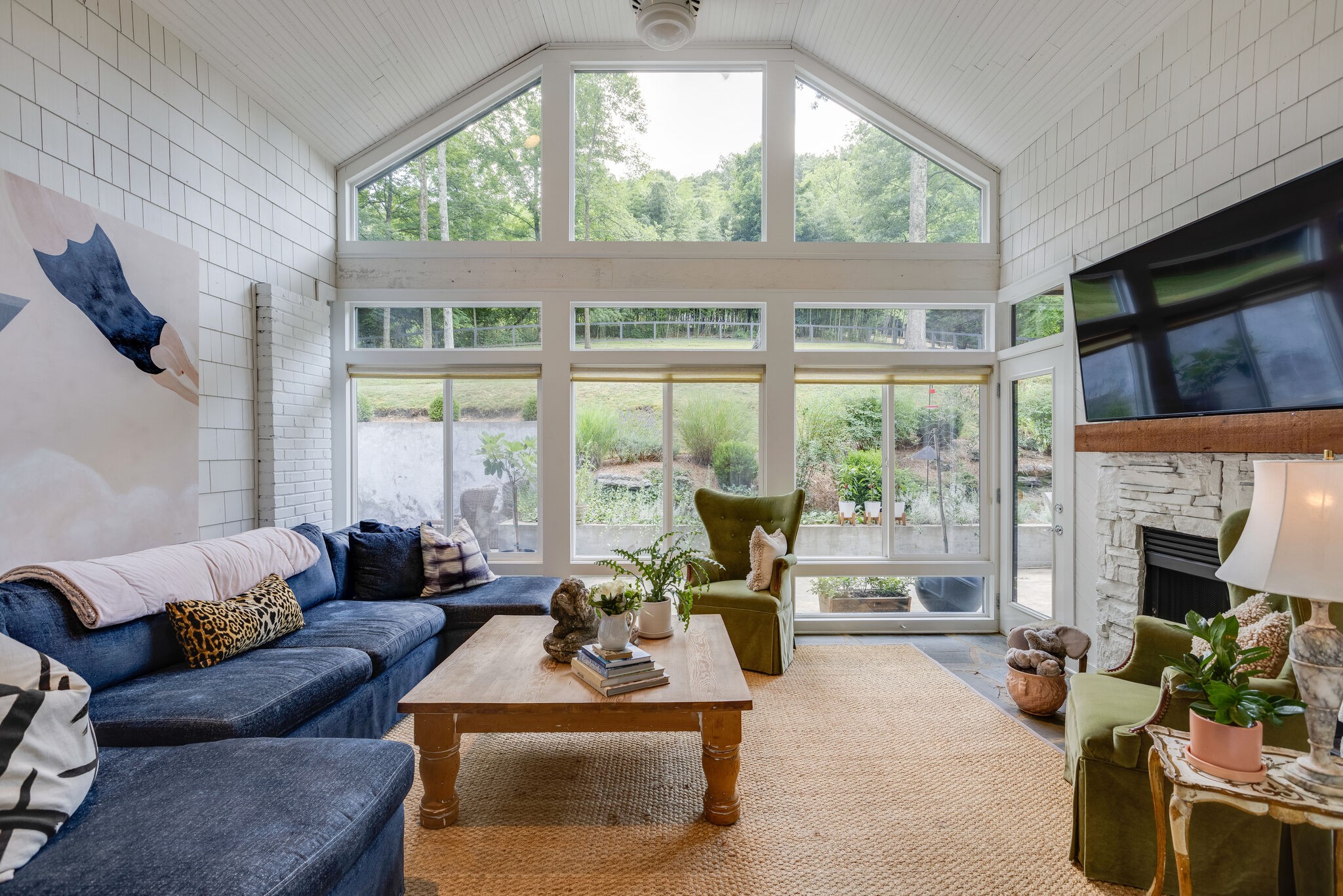 915 Overton Lea Road Nashville, TN 37220 - Photo 22 of 47 a living room with furniture large windows and a fireplace