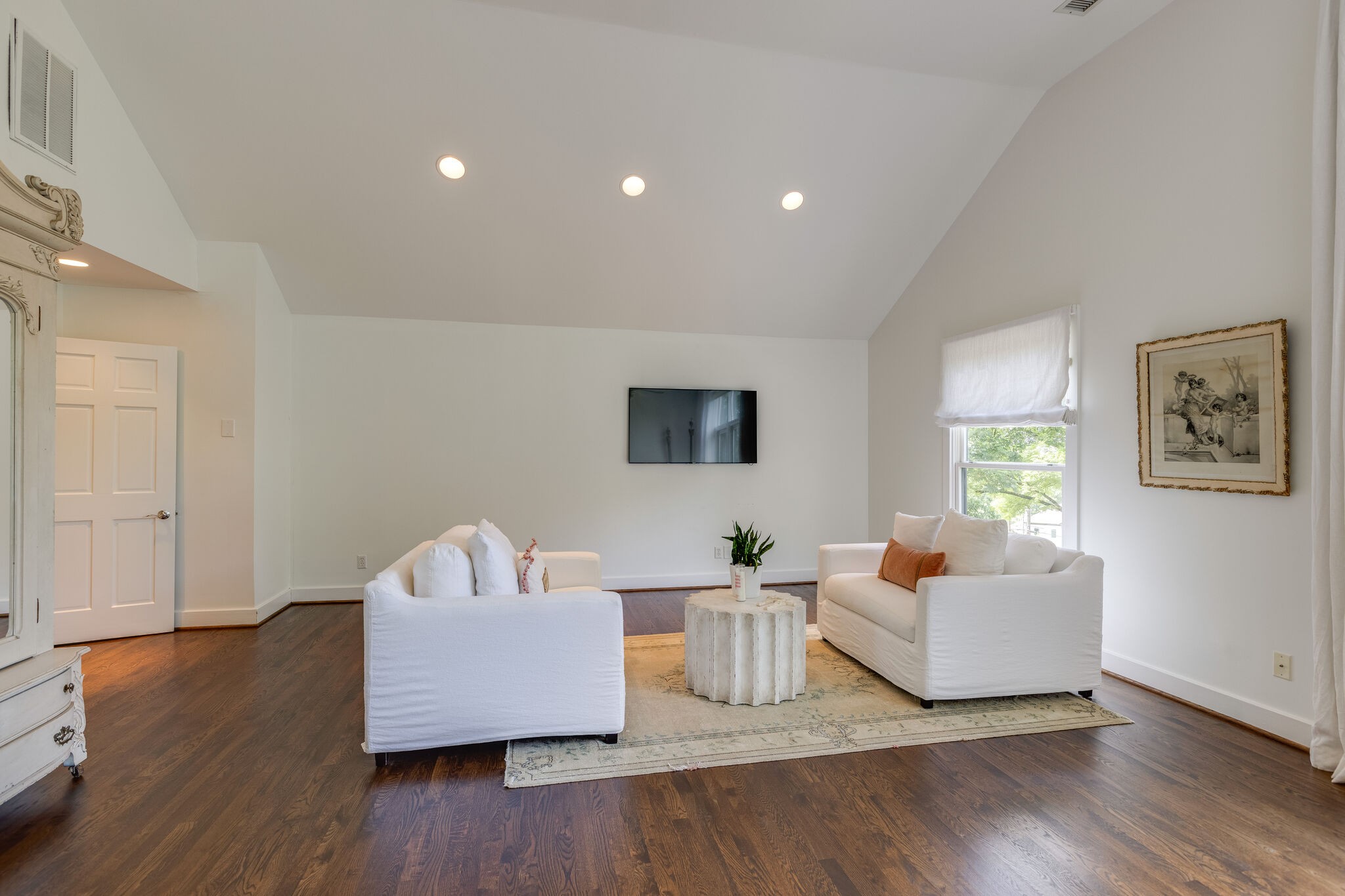 915 Overton Lea Road Nashville, TN 37220 - Photo 28 of 47 a living room with couches and a night stand with wooden floor
