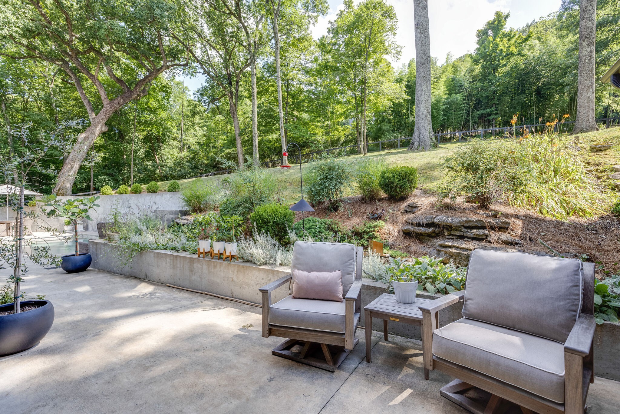915 Overton Lea Road Nashville, TN 37220 - Photo 36 of 47 a view of a chairs and table in the backyard