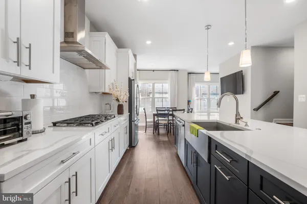 a large kitchen with stainless steel appliances lots of counter space and a sink
