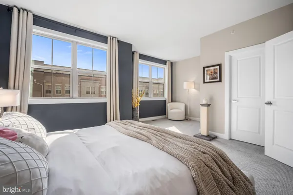 a bedroom with a large bed and a window