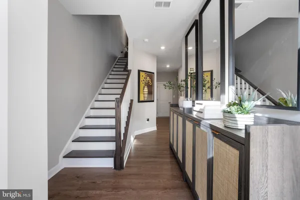 a kitchen with stainless steel appliances granite countertop a sink and dishwasher a oven with wooden floor