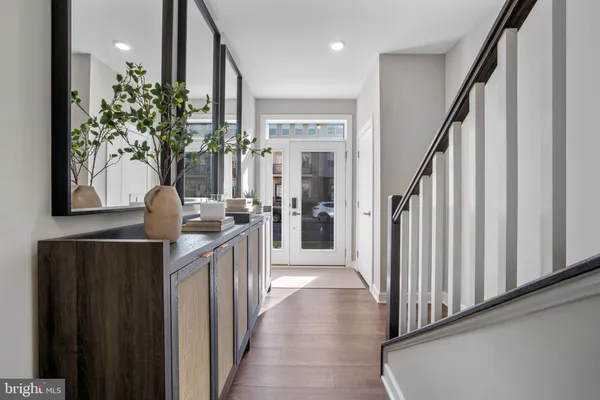 a view of a hallway and entryway with wooden floor