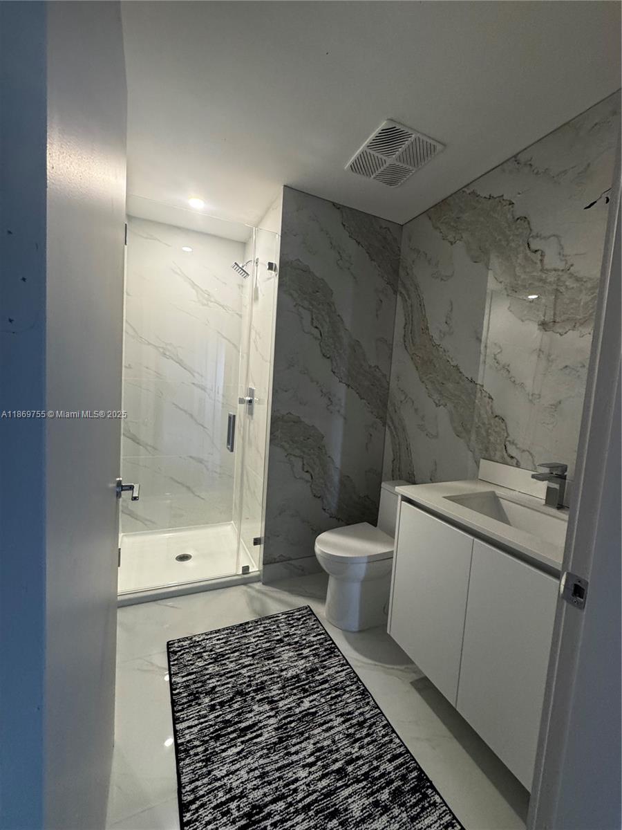 700 Northeast 24th Street, Unit 2206 Miami, FL 33137 - Photo 14 of 41 a bathroom with a sink toilet and shower