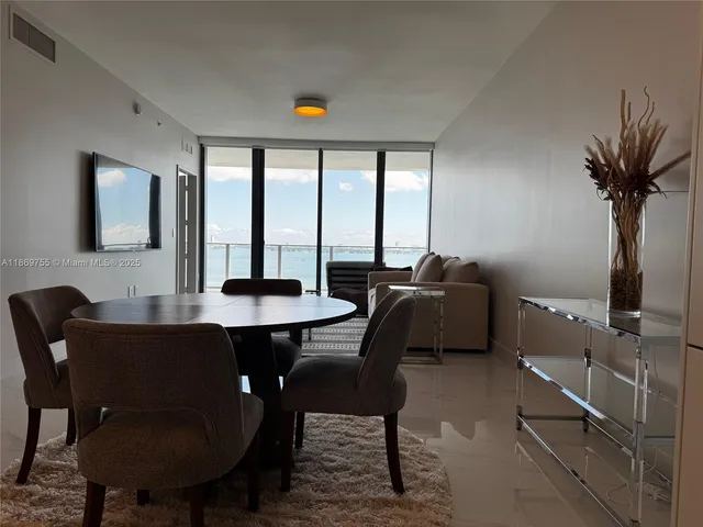 a dining room with furniture and window