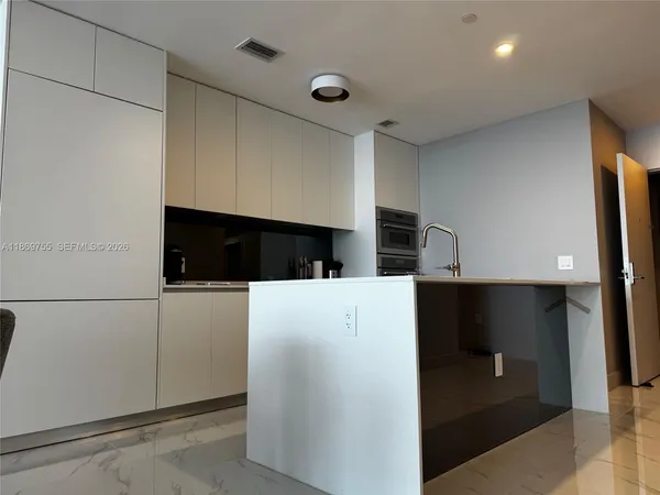 a kitchen with a stove a sink and a refrigerator