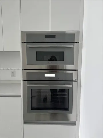 a stove top oven sitting inside of a kitchen
