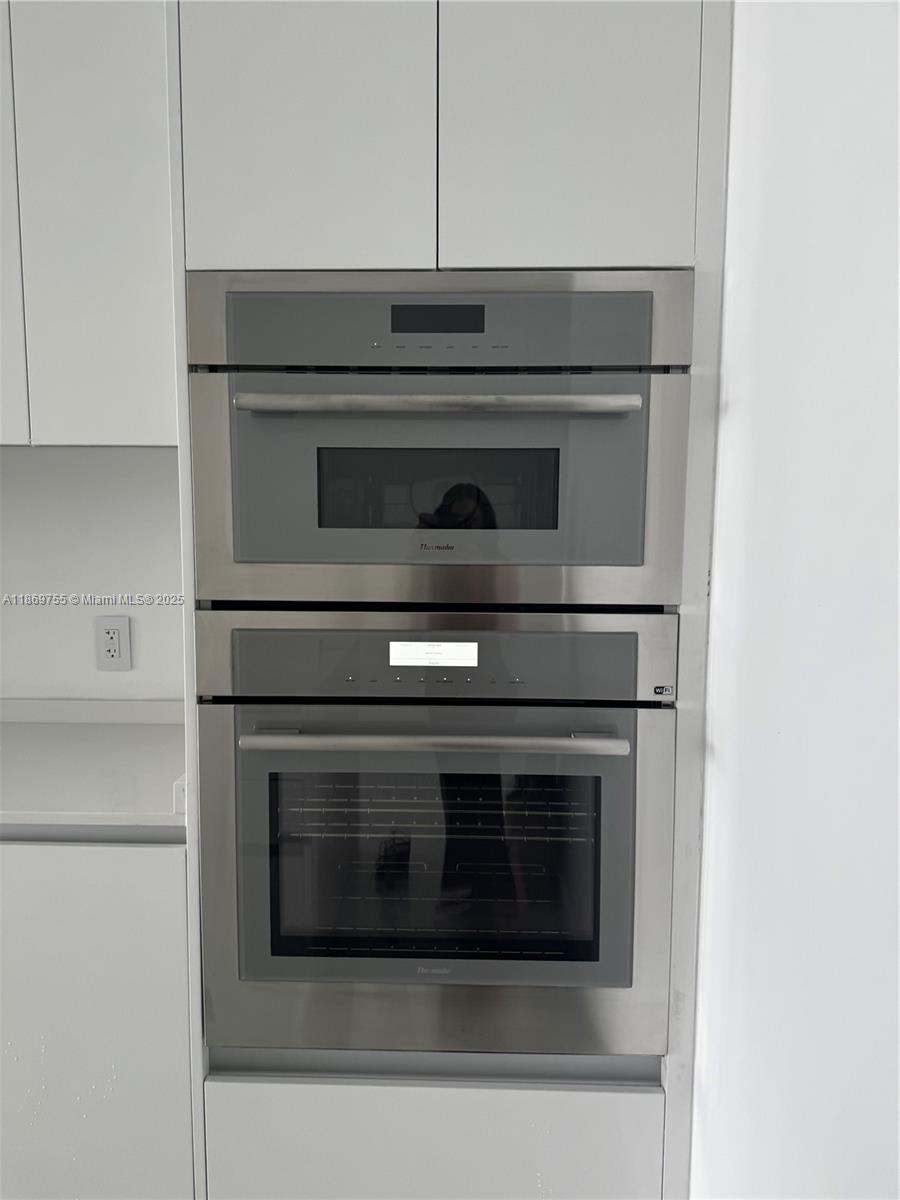 700 Northeast 24th Street, Unit 2206 Miami, FL 33137 - Photo 22 of 41 a stove top oven sitting inside of a kitchen