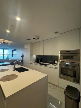 a stove top oven sitting inside of a kitchen