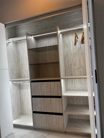 a view of staircase with white walls and a window