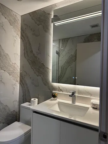 a bathroom with a sink and mirror