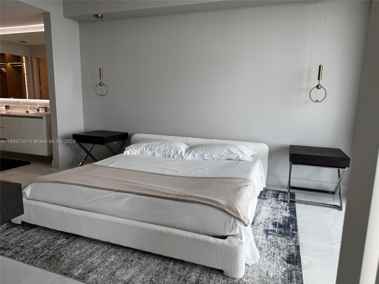 700 Northeast 24th Street, Unit 2206 Miami, FL 33137 - Photo 37 of 41 a bedroom with a bed and a tv