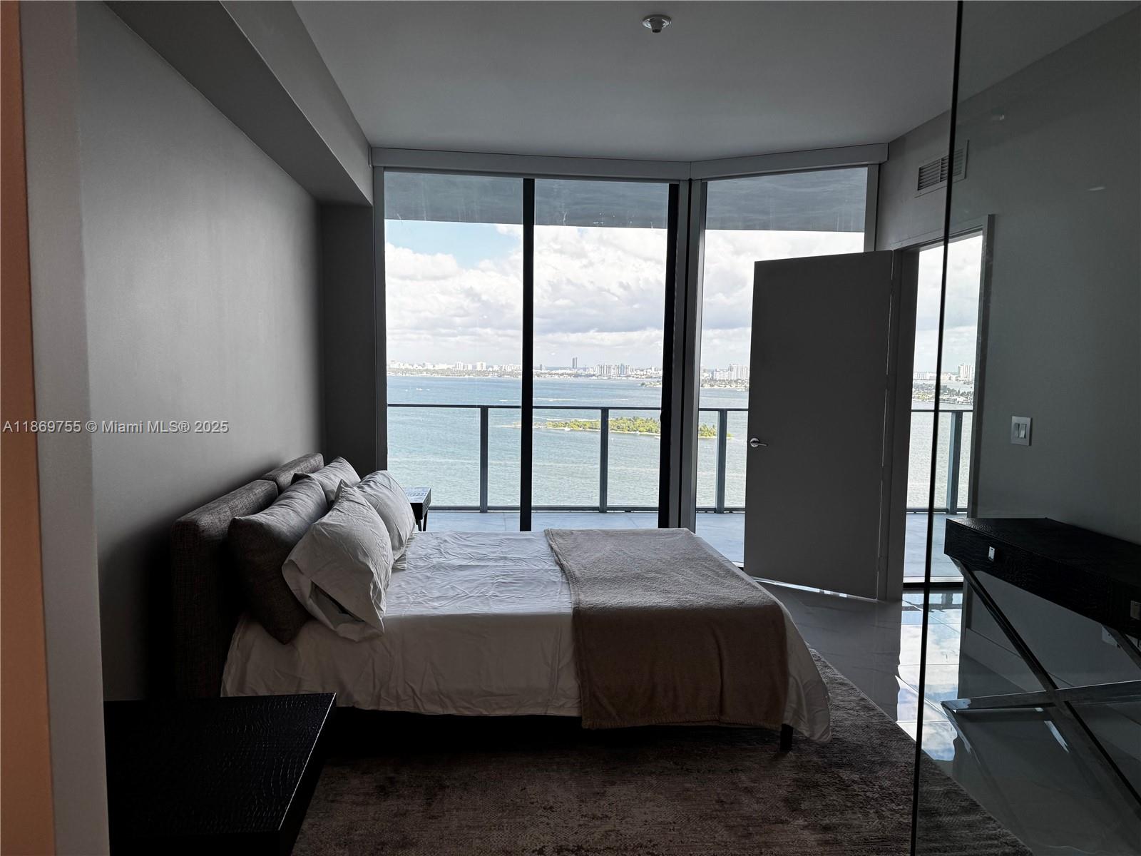 700 Northeast 24th Street, Unit 2206 Miami, FL 33137 - Photo 7 of 41 a bedroom with a bed and a large window