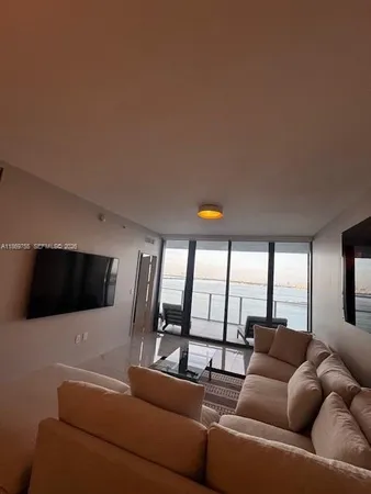 a living room with furniture and a large window