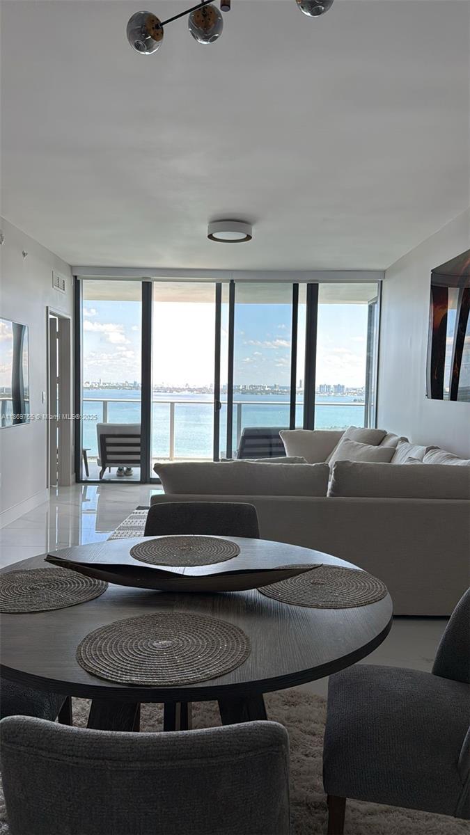 700 Northeast 24th Street, Unit 2206 Miami, FL 33137 - Photo 10 of 41 a living room with furniture and a floor to ceiling window