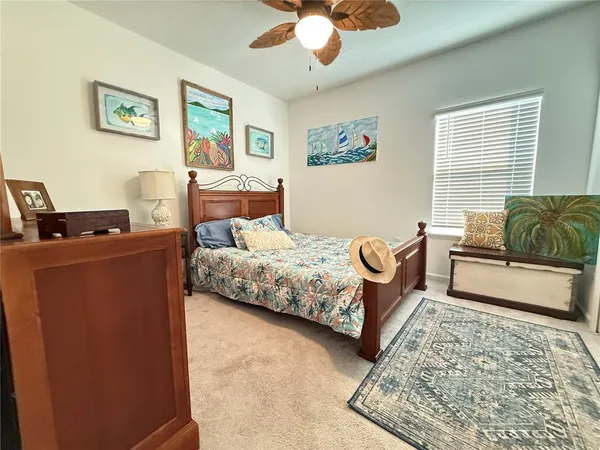 a bedroom with bed couch and window
