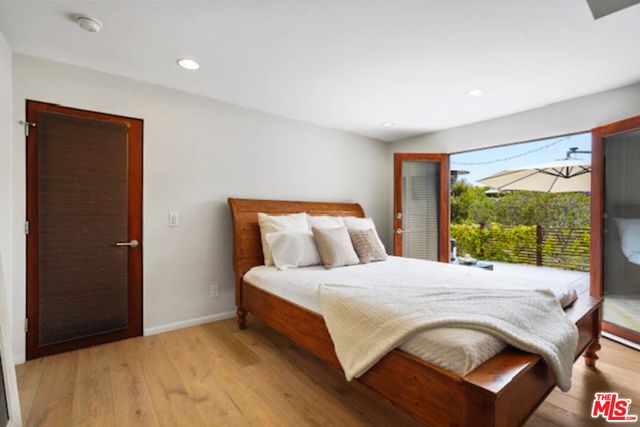 a bedroom with a bed and large window