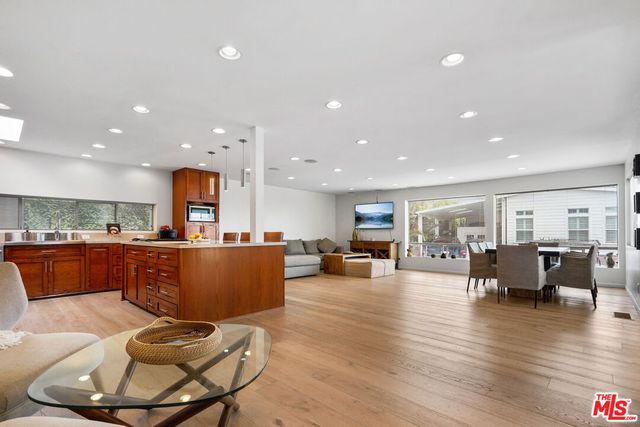 a living room with furniture and kitchen view